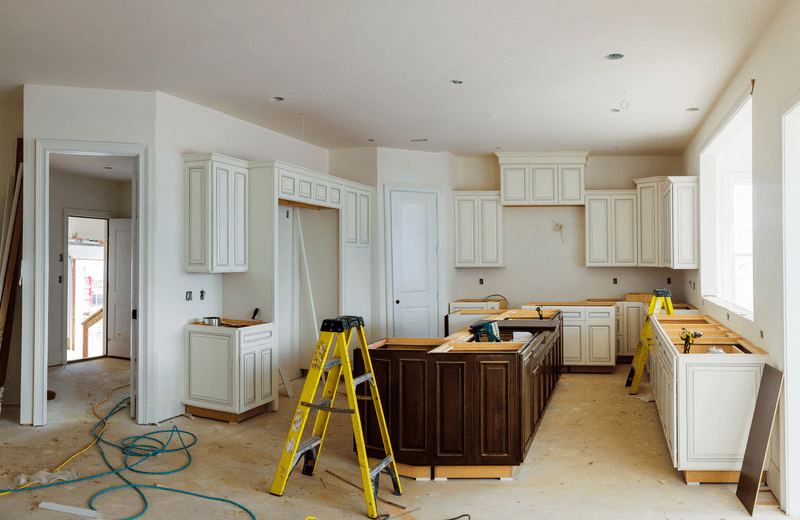 Kitchen mid-renovation with construction dust and debris to be cleared
